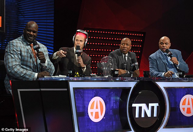 Next to the NBA team (L-R) Shaquille O'Neal, announcer Ernie Johnson Jr., wearing an iGrow laser helmet for hair growth, Kenny Smith and Charles Barkley