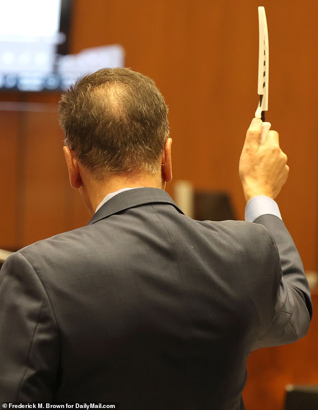 The murder trial, presided over by Judge Mildred Escobedo, featured dramatic scenes as the Los Angeles deputy district attorney held up the alleged murder weapon - a knife - and its sheath for the jury to examine.