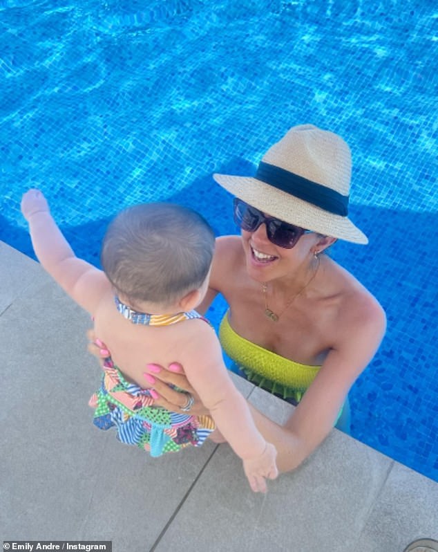 Emily looked like she was on cloud nine as she took a dip in the pool with Arabella on Tuesday