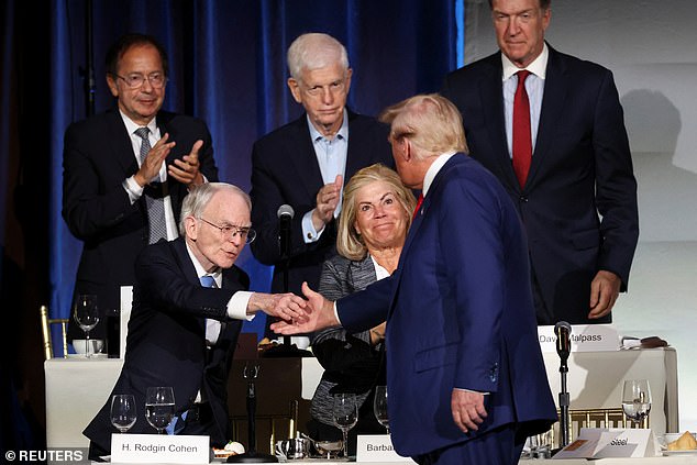 Republican presidential candidate and former U.S. President Donald Trump shakes hands with Sullivan & Cromwell Senior Chairman H. Rodgin Cohen at the Economic Club of New York