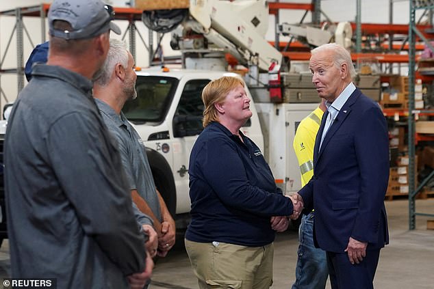 President Joe Biden (R) speaks to Vernon Electric Cooperative workers in Westby, Wisconsin, on Thursday before delivering a speech on rural power in the key swing state