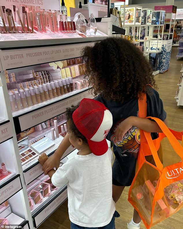 In a photo where the children's faces are not visible, Stormi and her brother look at her mother's cosmetics at Ulta