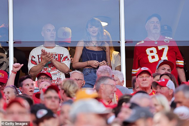 Swift watched the game with her boyfriend's father, Ed (right), in a private suite