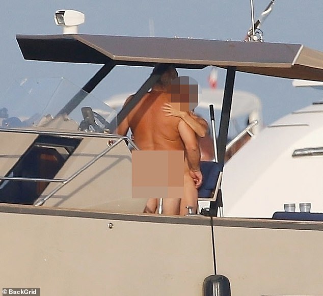 As Ronaldo and Georgina packed on their PDA, a couple - completely naked - sailed by on their boat