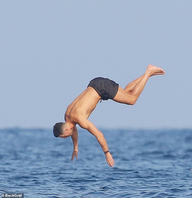 Cristiano attempted an impressive somersault as he entered the water