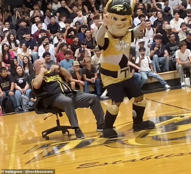 Students appeared amused as the mascot touched Nunes' face as music blared