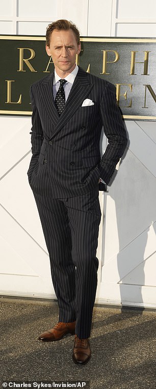 Tom, 43, kept a dapper appearance in a pinstripe suit and a striped navy and white shirt