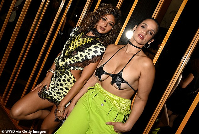 Wearing a black choker and large, solid silver rings, she posed next to her friend, who held her fingers