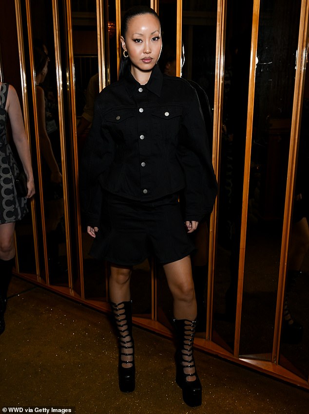 Fiffany Luu looked stylish in a flowy black denim dress and black multi-strap boots that hit just below the knee