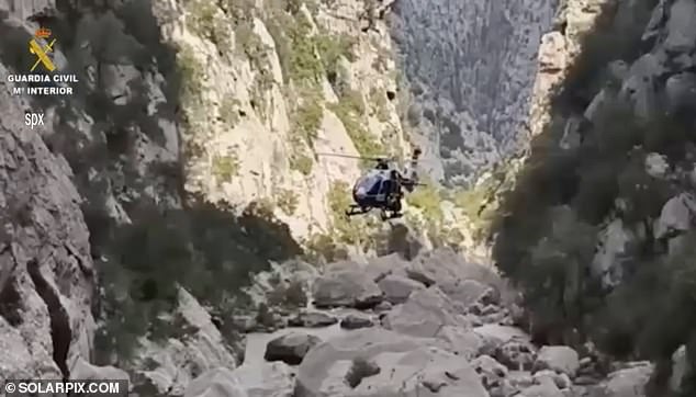 The head of the Guardia Civil's specialist mountain rescue team yesterday remained confident they would find Mr Johnson's body (Pictured: A helicopter searching the gorge)