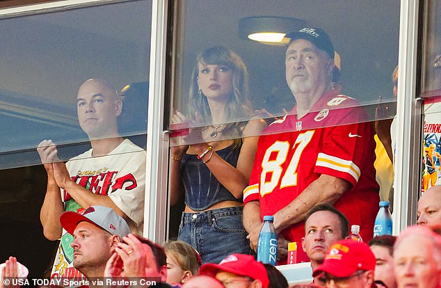 Taylor watched the game Thursday night in a private suite next to Travis' father Ed (right)