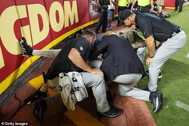 Baltimore Ravens head coach John Harbaugh and the team are seen watching Likely