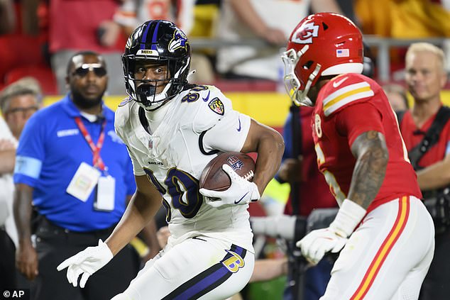 Baltimore Ravens tight end Isaiah Likely (80) runs past Kansas City Chiefs safety Bryan Cook