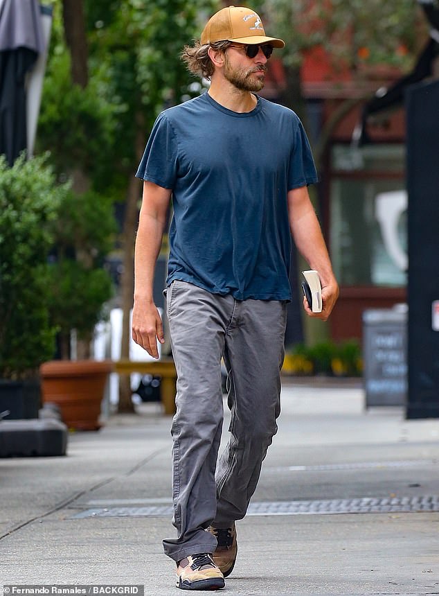 He offered himself a little shade with a baseball cap and dark sunglasses, and completed the look with on-trend faded gray jeans and a pair of sneakers.