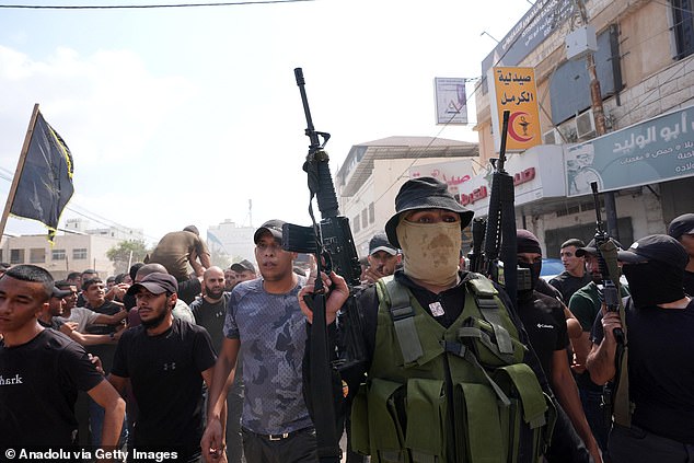 It comes after Israeli troops withdrew from three refugee camps in Jenin in the occupied West Bank on Friday morning. Pictured: Mourners at the funeral of eight Palestinians who died in the attacks