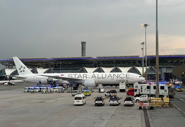 One passenger died and 30 others were injured on a flight from London to Singapore this afternoon, forcing an emergency landing in Thailand. Pictured: The plane and ambulances are seen on the tarmac at Suvarnabhumi International Airport in Bangkok on May 20