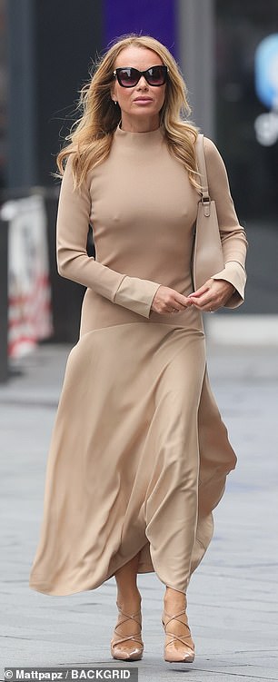 Dressed in a Florere knitted top woven skirt midi dress, which cost £198 from John Lewis, the blonde beauty looked incredible as she strutted through London