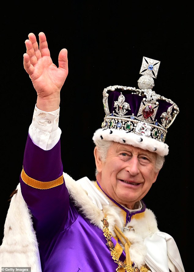 King Charles III waves from the balcony of Buckingham Palace after the coronation service in May last year