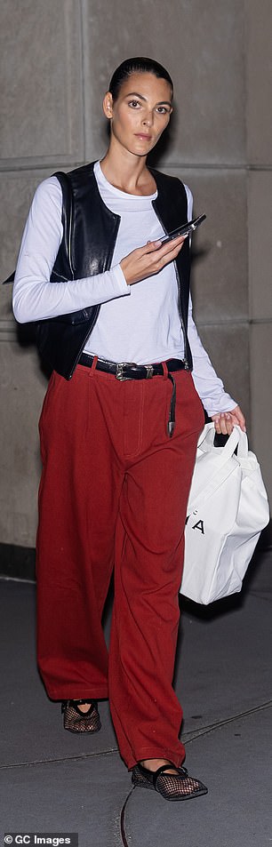 Leonardo DiCaprio's girlfriend Vittoria Ceretti, 26, showed off her cool style in a long-sleeved white top, a black leather vest and bright red oversized pants