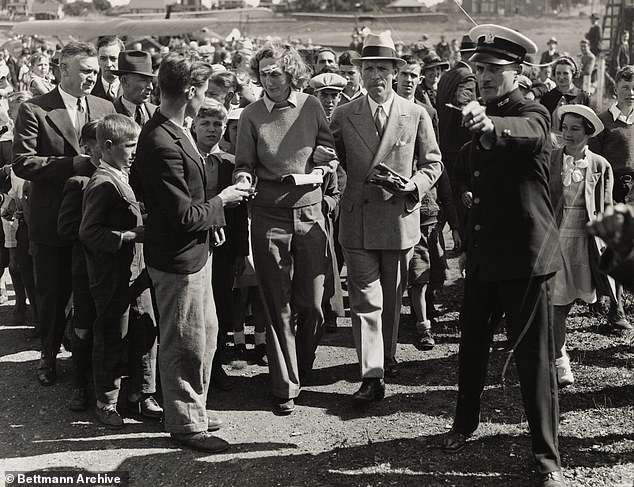 A crowd of autograph hunters storm Beryl Markham after her solo flight across the Atlantic Ocean