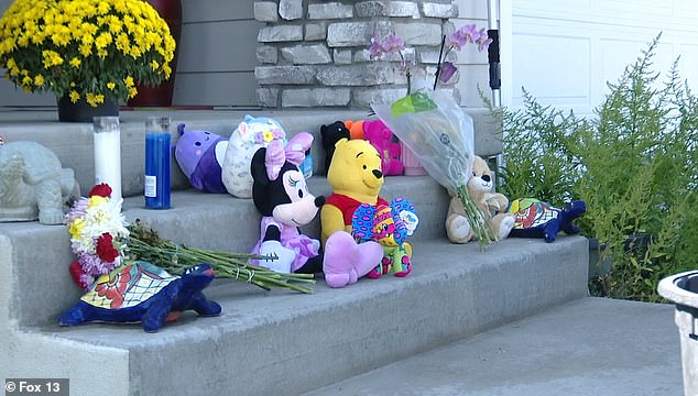 Friends, family and neighbors laid flowers and stuffed animals on the steps of the memorial