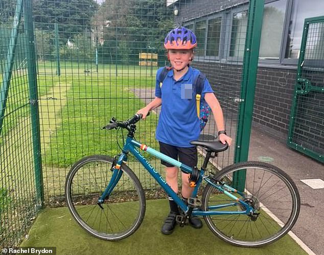 Freddie, nine, here with his bike at the school gate.