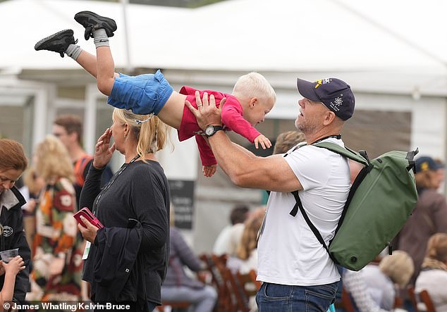 Mike spins three-year-old Lucas around in the air in the friends and family area