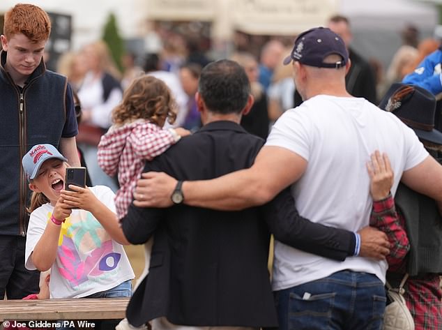 The royal also stopped to take photos with fans who spotted him during a day out with his family - captured by his eldest daughter, 10-year-old Mia (above)