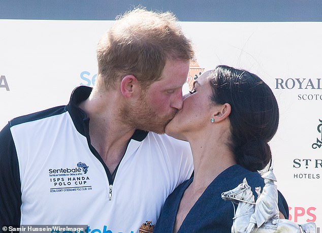 The Duke and Duchess of Sussex kiss at the trophy presentation at the Sentebale Polo held in Windsor, England on July 26, 2018.