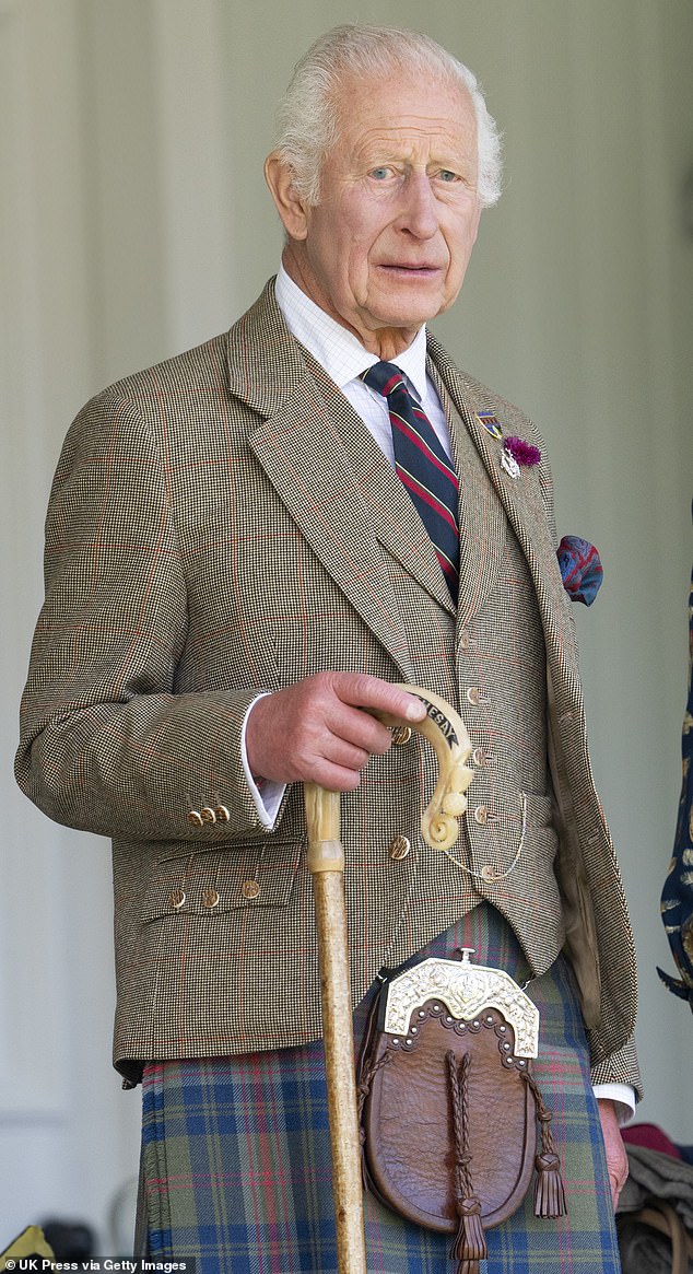 The king wore a checked coat and a navy blue, red and green kilt