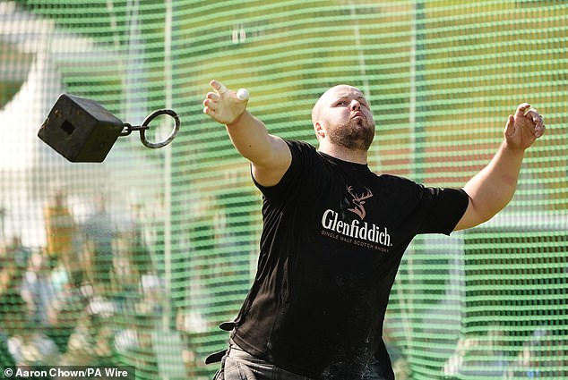 A competitor throws a 28 pound weight during the Braemar Gathering Highland Games