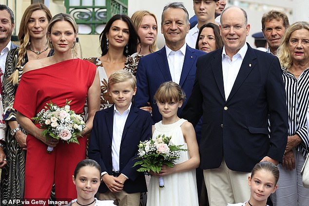 Prince Jacques was his father's doppelganger and wore a similar outfit (pictured from right to left: Prince Albert II, Princess Gabriella, Prince Jacques and Princess Charlene)