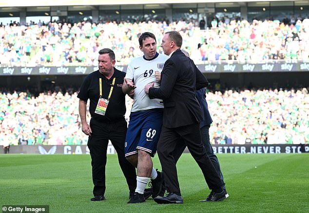 A fully kitted out fan - later revealed to be internet prankster Jarvo - ran onto the pitch and joined the England squad before kick-off