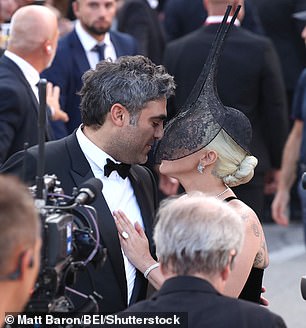 She was seen going inside to give her fiancé a loving kiss, despite wearing a veil over much of her face