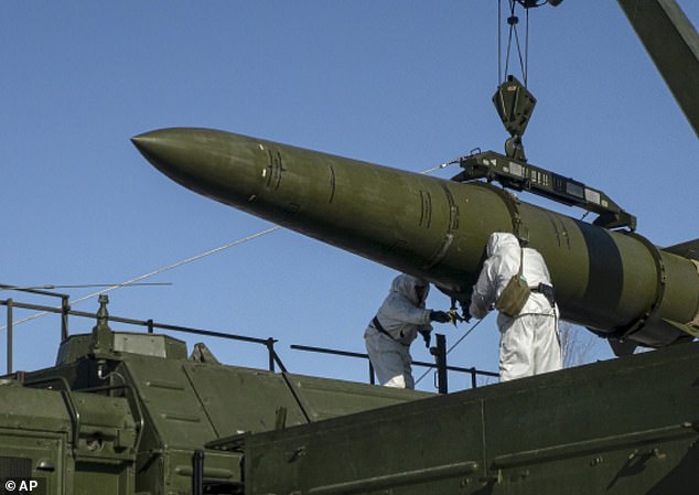 Russian troops load an Iskander missile onto a mobile launcher during exercises at an undisclosed location in Russia