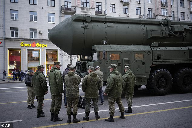 Soldiers stand next to a Russian RS-24 Yars ballistic missile parked along Tverskaya Street ahead of a rehearsal for Moscow's Victory Day military parade