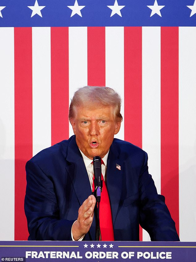 Donald Trump gestures as he addresses the Fraternal Order of Police during their rally in Charlotte, North Carolina, on Friday