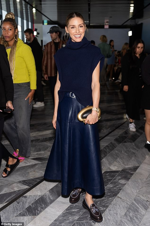 Olivia Palermo also caused a stir in a navy sleeveless knitted top and a faux leather maxi skirt