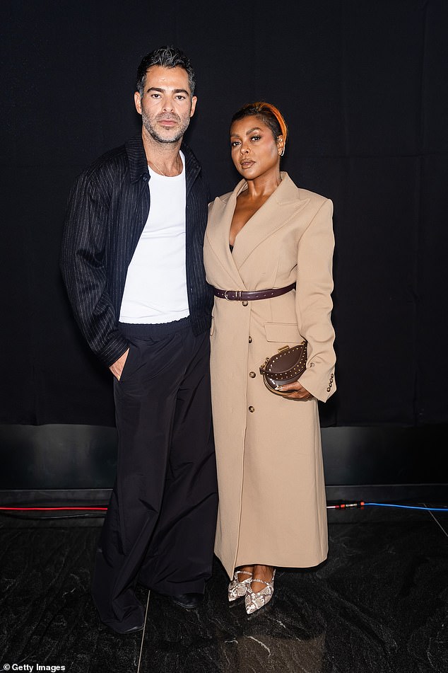 She carried a brown clutch as she posed with designer Jonathan Simkhai