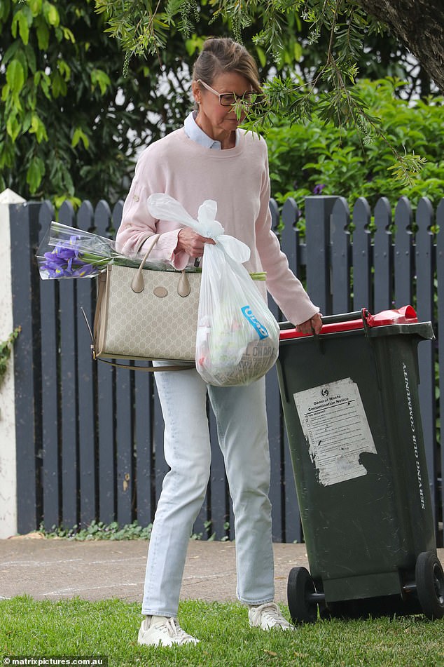 The journalist put on glasses to frame her face and looked somber as she left her late mother's house