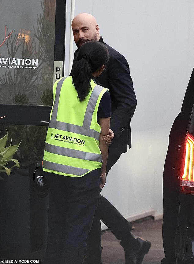 He completed his elegant look with a pair of black boots and appeared to be in good spirits as he was greeted by ground crew