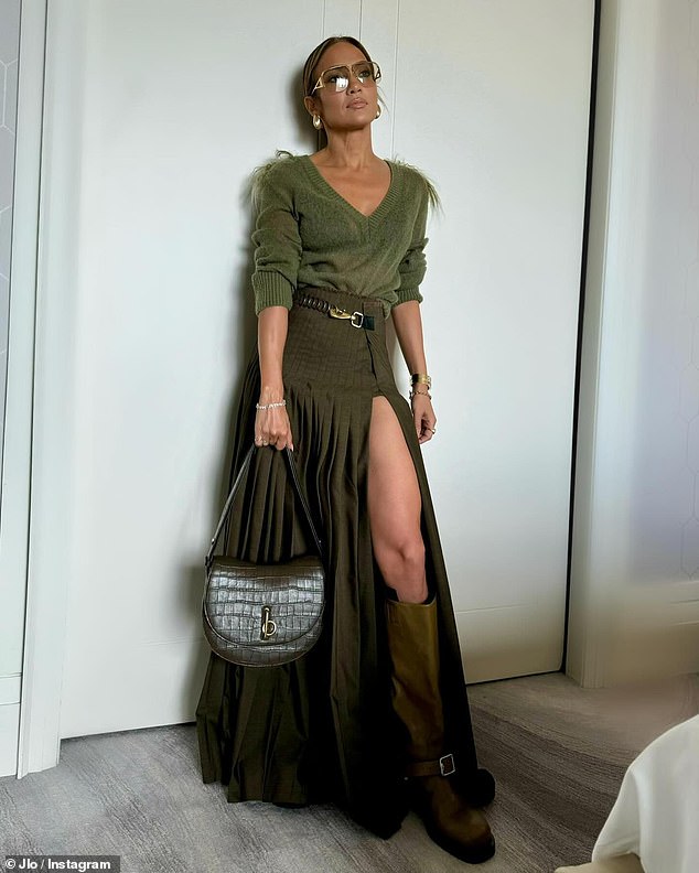 The hitmaker was dressed in a simple yet sexy olive green sweater with a V-neck and a high-waisted faux wrap maxi skirt with pleats and a thigh-high slit from Burberry. She also wore knee-high boots from the brand