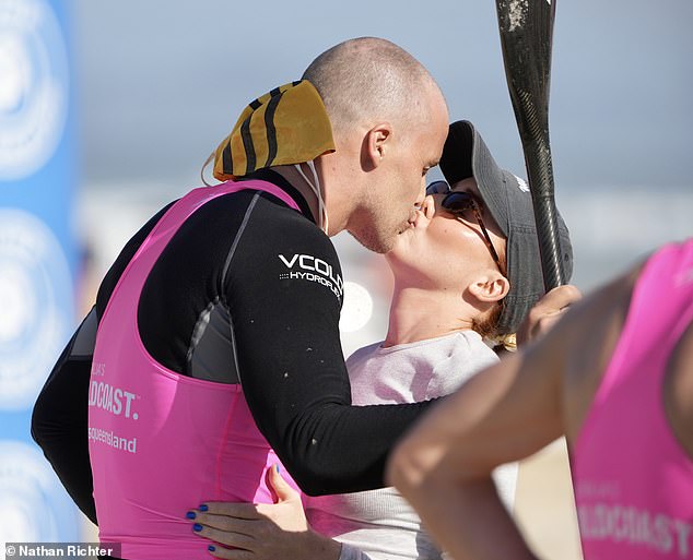 Lily, 25, was on hand to give her man a sweet kiss after he emerged from the water in a black wetsuit and pink tank top with a paddle in her hands