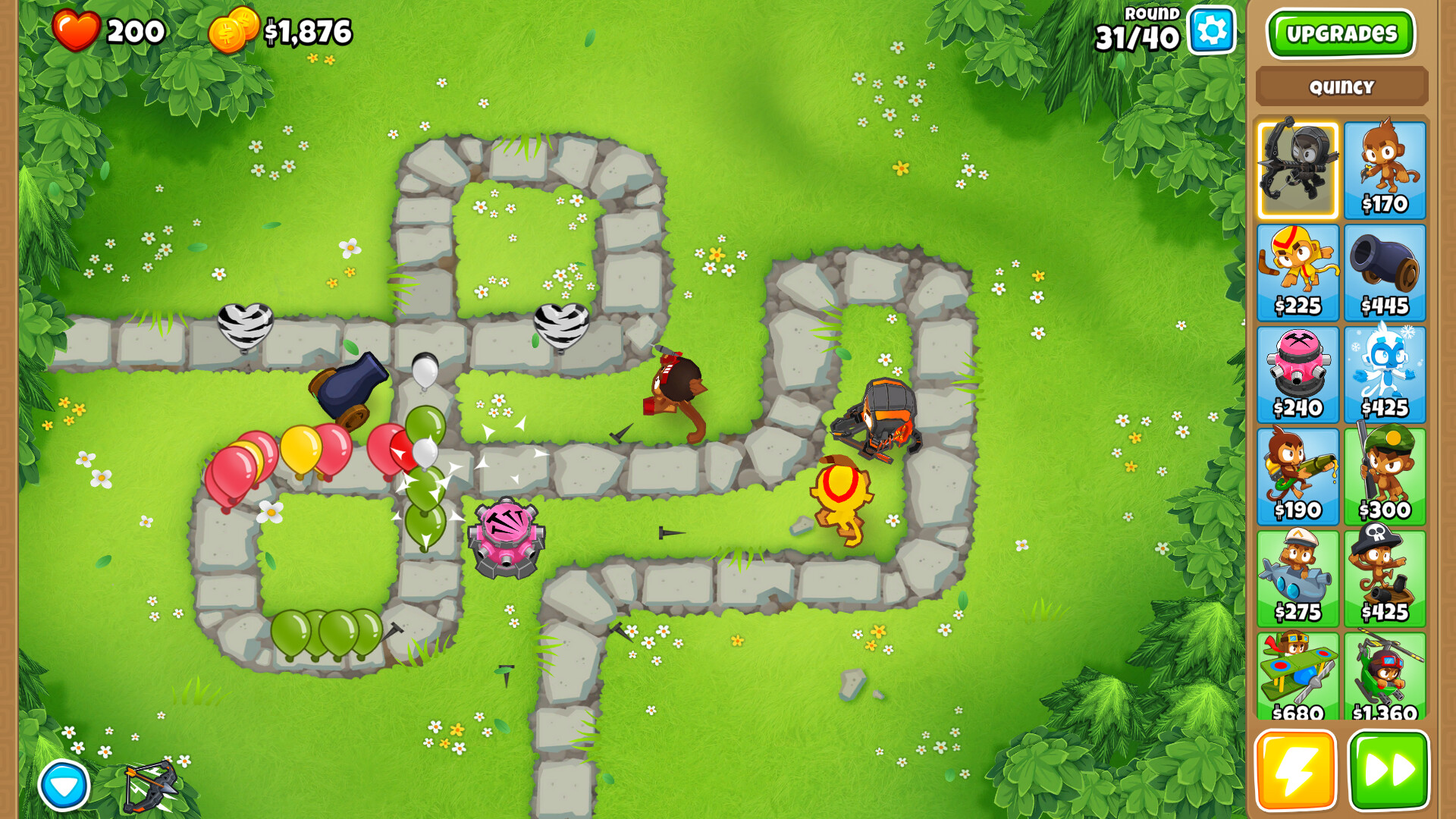 Several balloons fly over a stone path while monkeys try to pop them with darts