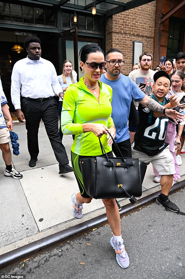 The American Idol judge showed off her slim figure in a highlighter green three-quarter zip top and black knee-length leggings with the same green design on the sides of her legs.