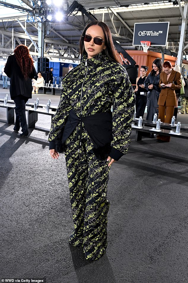 The former Little Mix member looked futuristic in a black and neon green floral quilted tracksuit as she posed for the show in Brooklyn Bridge Park, New York City