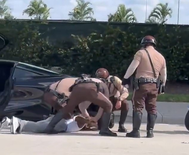 Video of the incident shows the 30-year-old being pinned to the ground