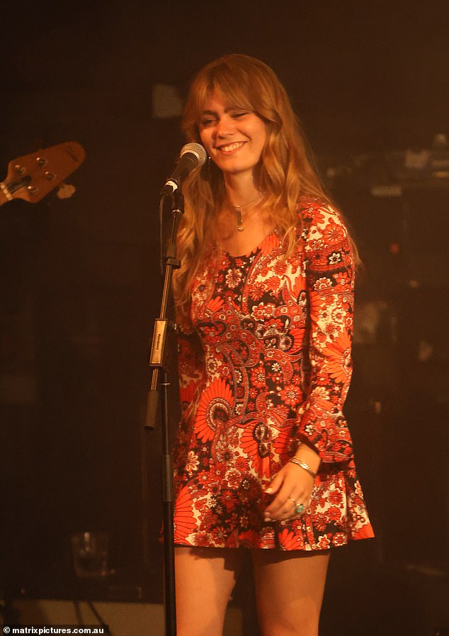 The rock star in training showed off her best features in a striking red floral dress, which accentuated her slim figure