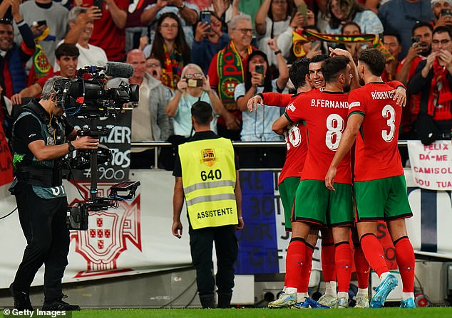 Ronaldo was mobbed by his Portuguese teammates as the Lisbon stadium exploded