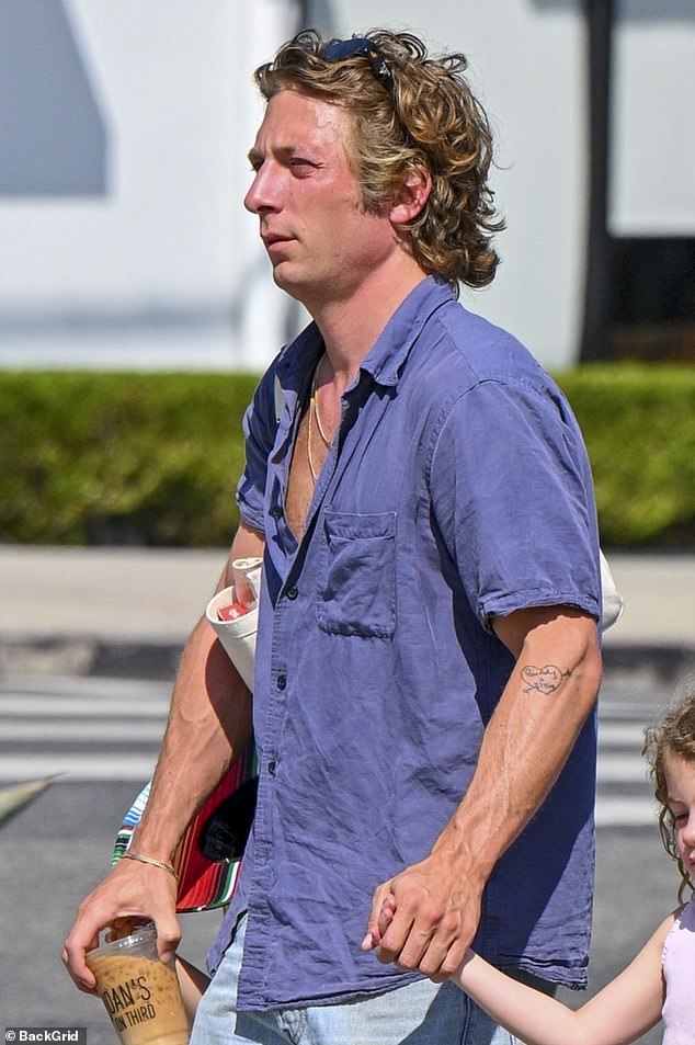 The Hollywood hunk wore sunglasses over his tousled blond curls and was clean-shaven